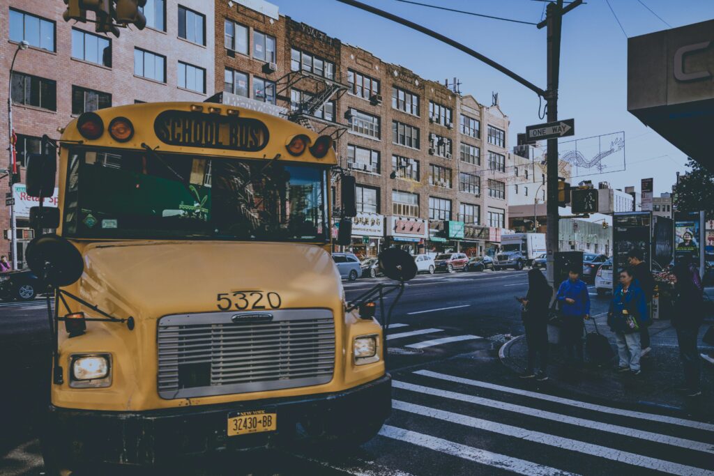 Group of students boarding a safe school trip bus rental in NYC with Zolo driver Group of students boarding a safe school trip bus rental in NYC with Zolo driver
