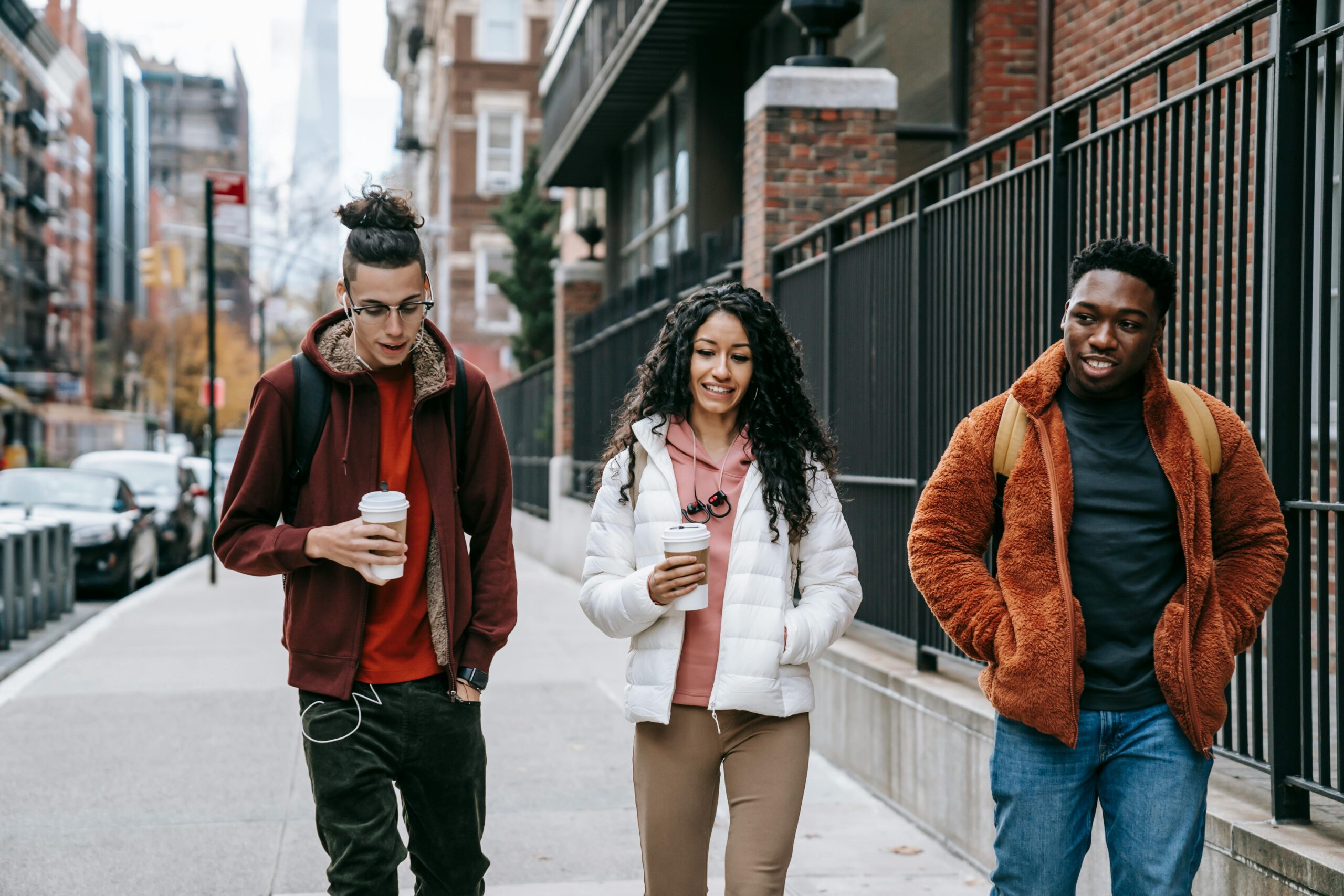 Budget Van Rental NYC in 2025: Your Handy Guide to Hauling Your Crew 7 Young glad multiracial partners with hot drinks to go strolling on urban pavement in daytime