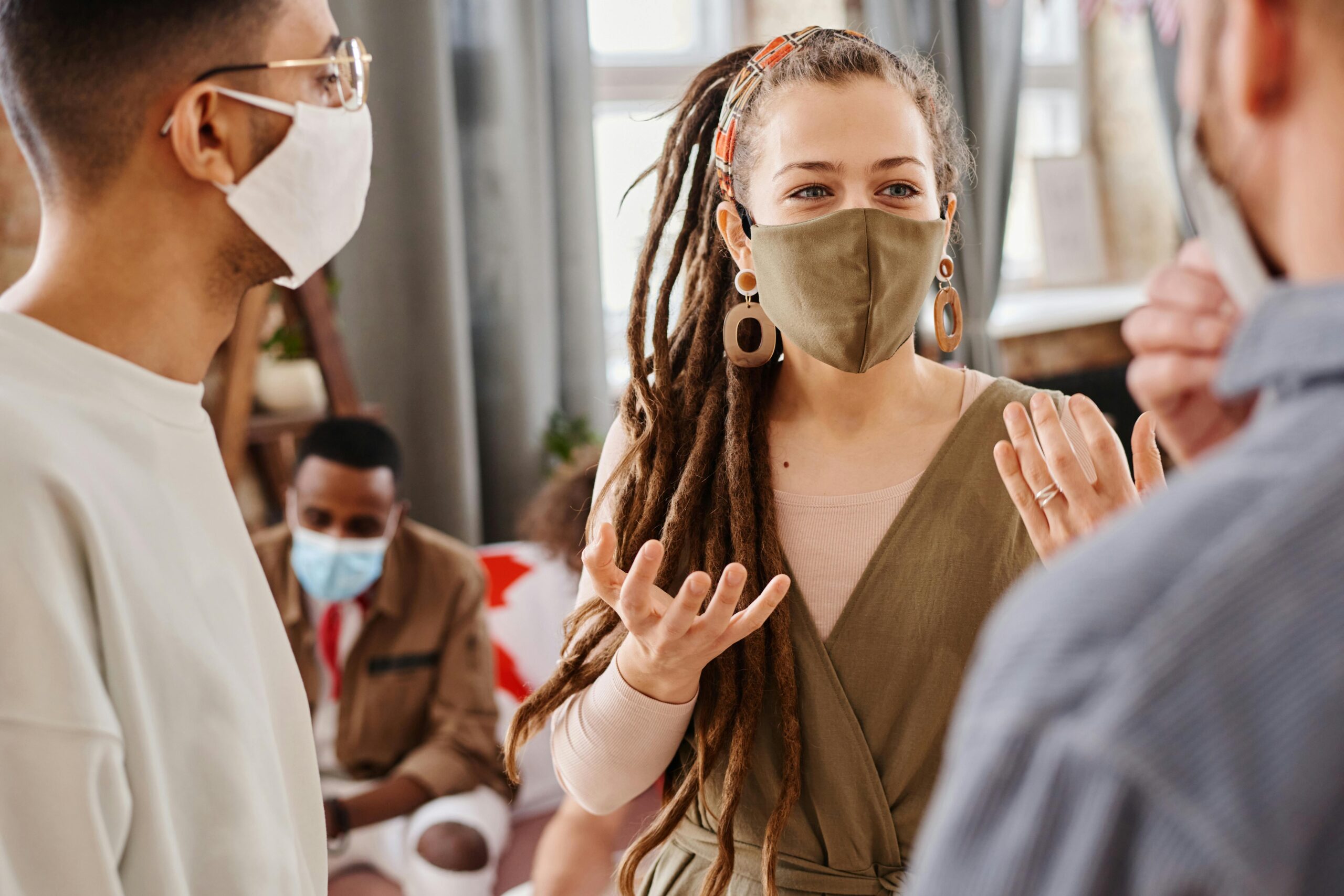 Party Bus Group Tours NYC: Your Ultimate 2025 Guide to Unforgettable Adventures 10 A group of diverse adults communicating indoors while wearing face masks.