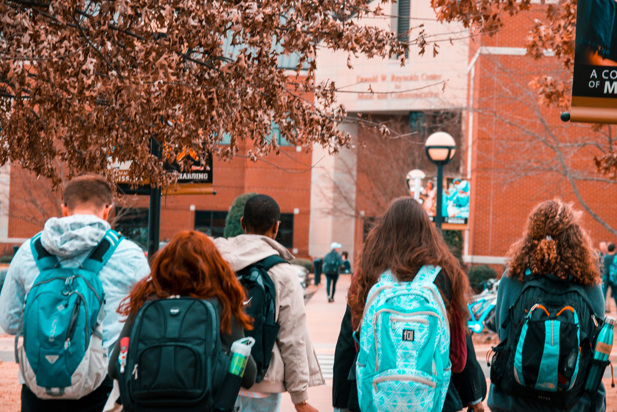 University Transportation Solutions: 5 Proven Seasonal Booking Strategies for 2026 10 A group of college students with backpacks walking together outdoors on campus.