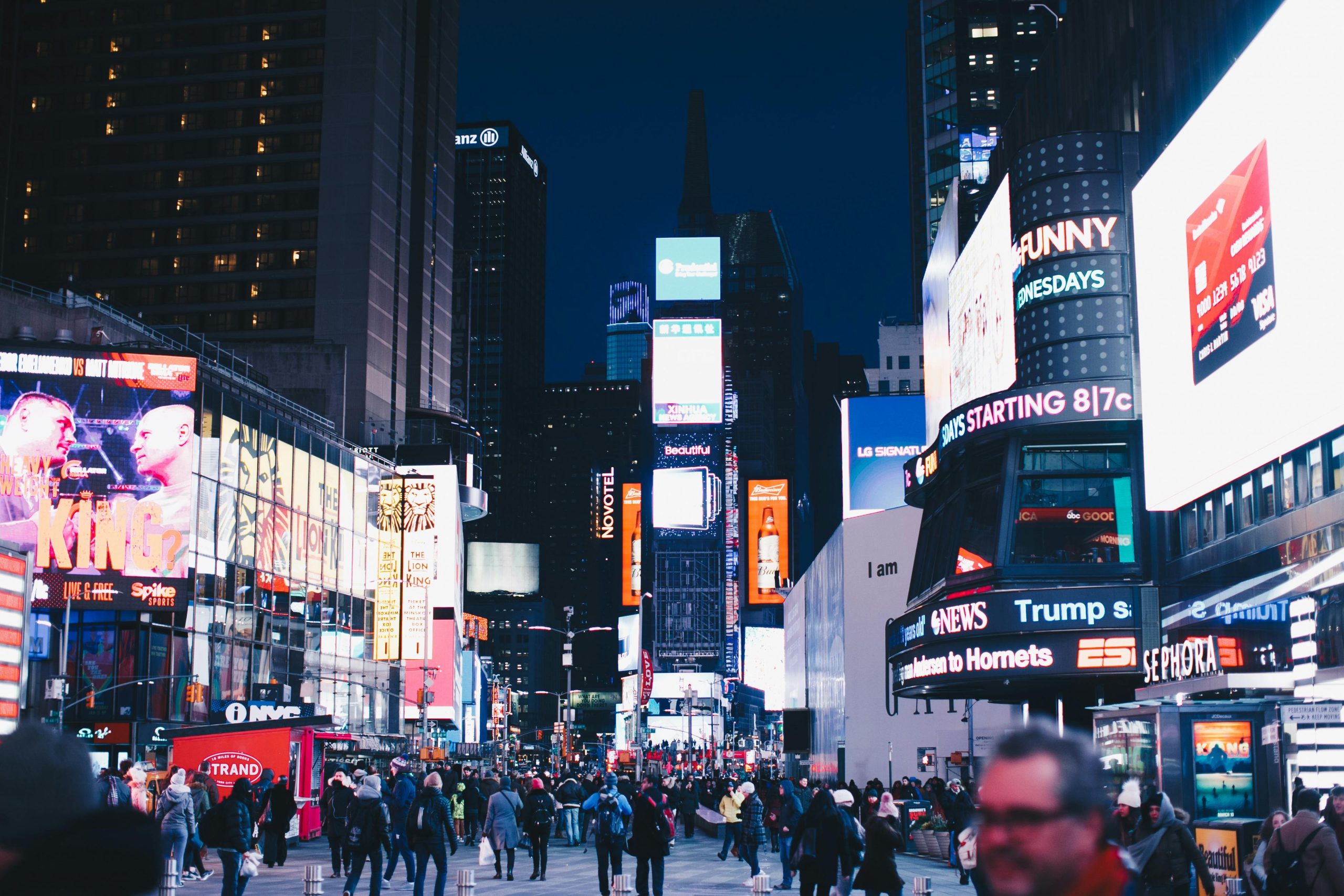 Event Transportation NYC: 6 Honest Comparisons for Construction Crews in 2026 2 Bustling night scene in Times Square, New York City, illuminated with vibrant advertisements.