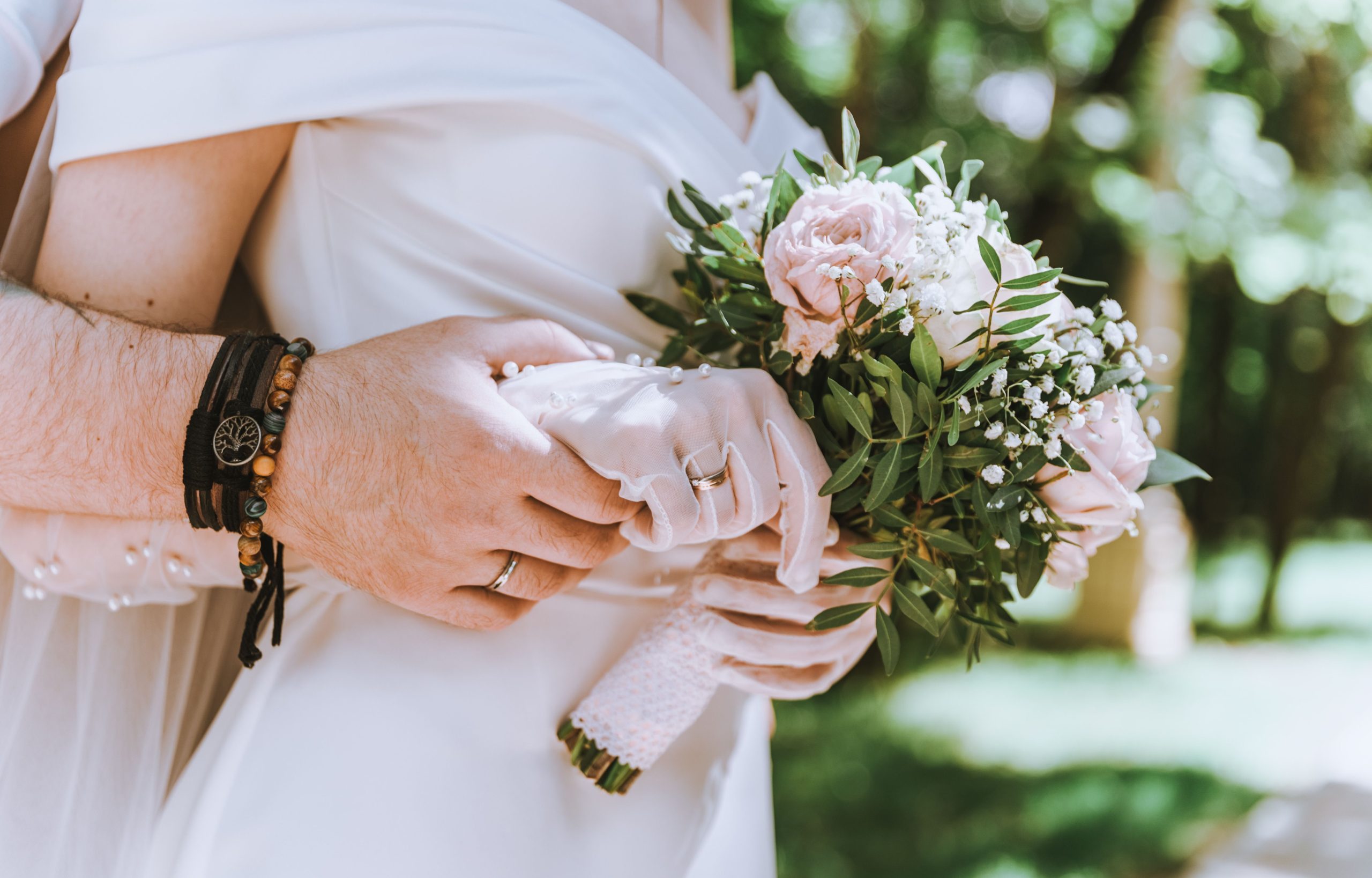 Wedding Shuttle Service NYC: A 2026 Planner's Honest Guide 8 Close-up of a bride and groom holding a floral bouquet, symbolizing love and marriage.