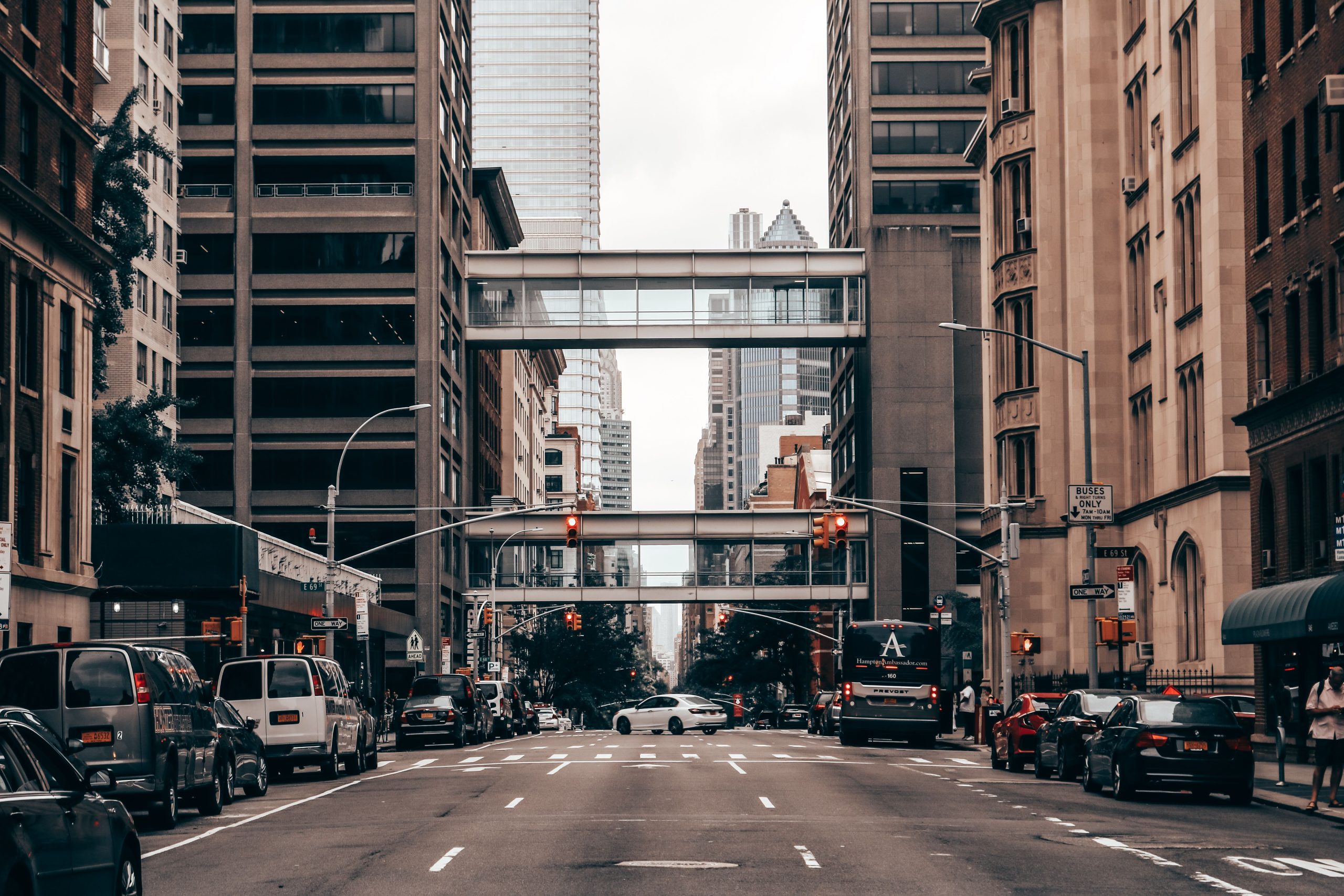 Group Transportation Services NYC: 5 Proven Seasonal Booking Secrets for 2026 2 Dynamic view of a busy New York City street with traffic and towering skyscrapers.
