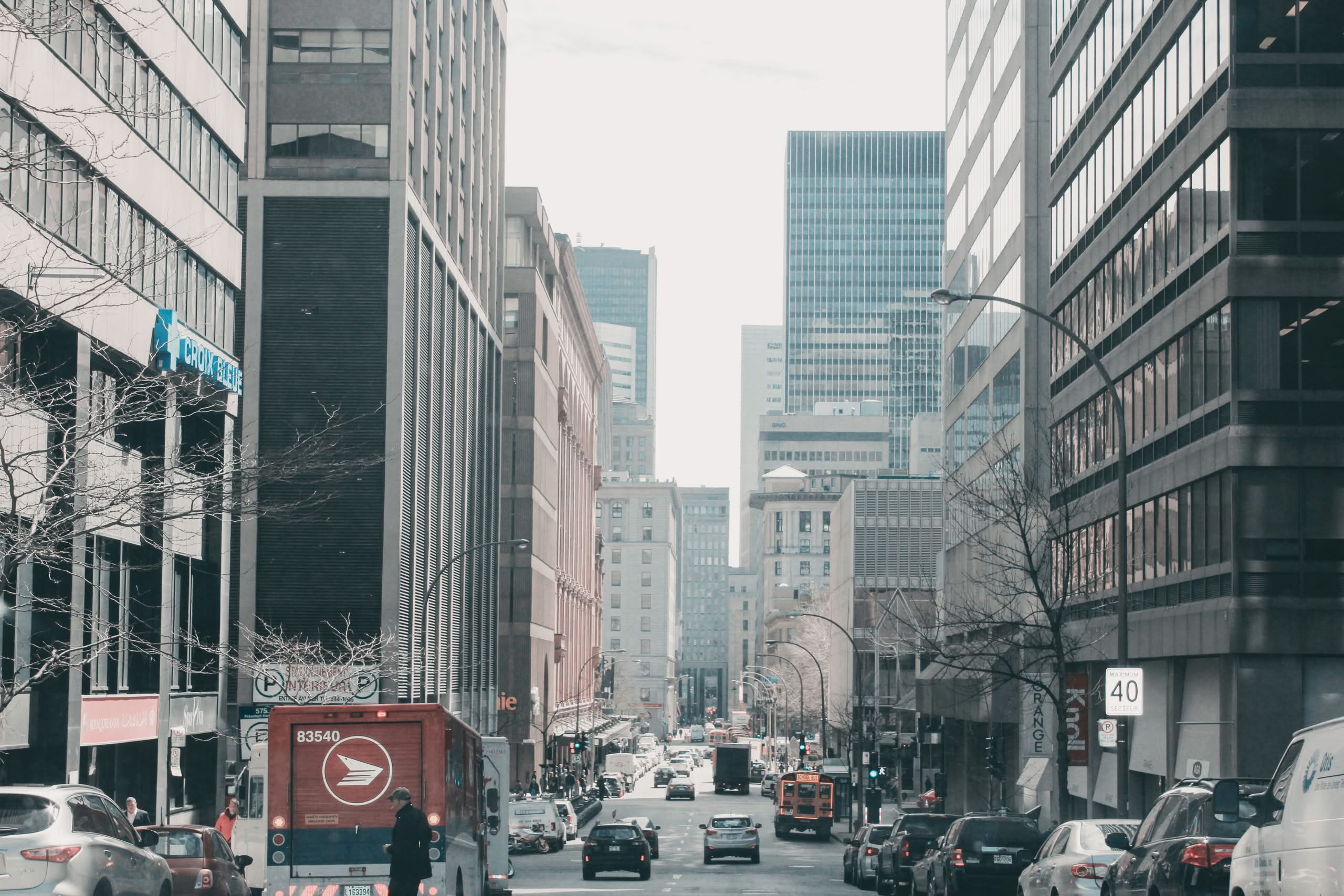 Luxury Mini Bus NYC: The Honest 2026 Seasonal Booking Guide 6 Lively street scene in downtown Montreal, showcasing urban architecture and bustling traffic.